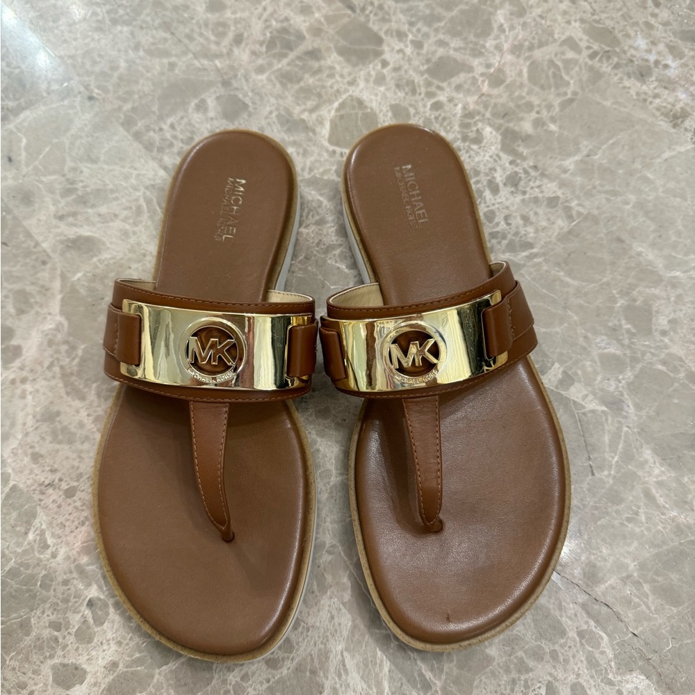 Brown MK sandals.